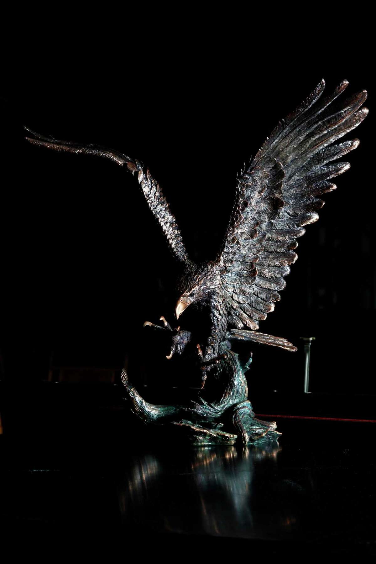 A bronze eagle statue, value unknown, will be auctioned off by Seth Worstell Auction Co., to raise funds that will be used in part to repay victims of imprisoned R. Allen's Stanford on Thursday, Sept. 27, 2012, in Houston. The Saint Croix, U.S. Virgin Islands, assets will be auctioned off which includes several golf carts, a baby grand piano and some expensive jewelry.