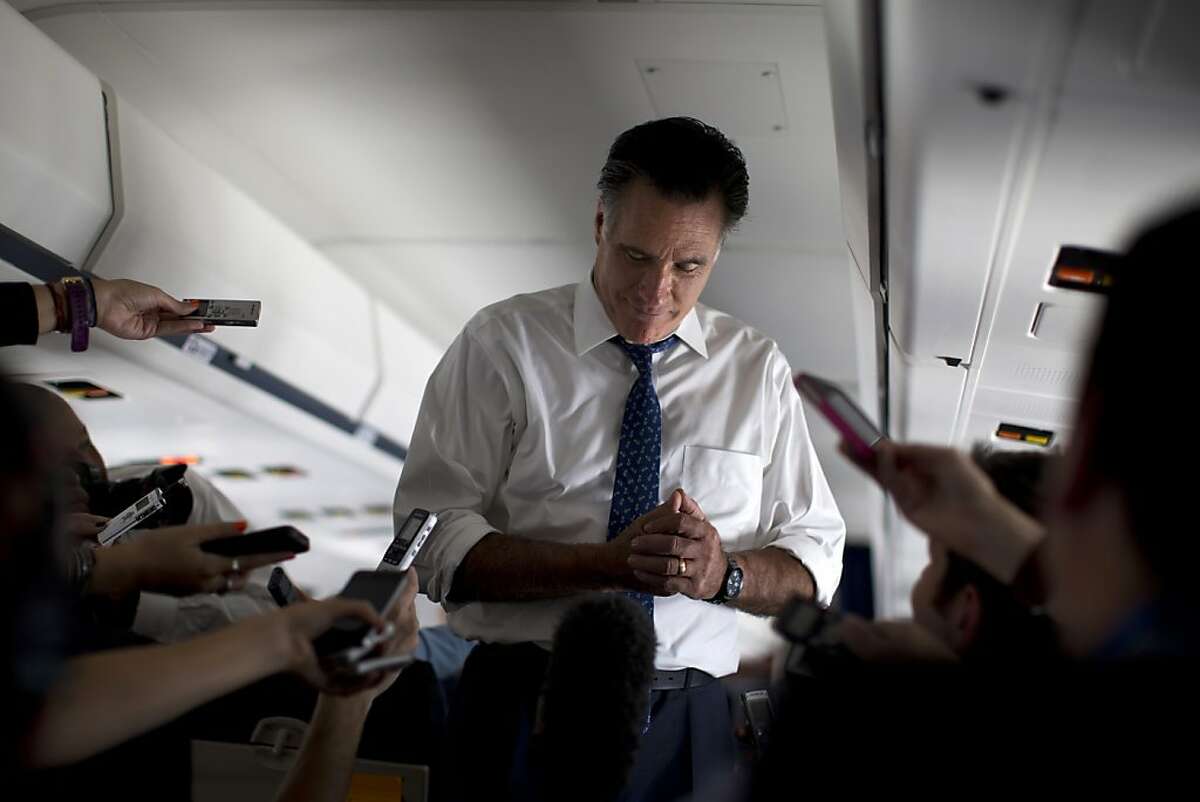 Republican presidential candidate, former Massachusetts Gov. Mitt Romney pauses as he speaks with the media aboard his campaign plane during a flight to Boston, Friday, Sept. 28, 2012. (AP Photo/ Evan Vucci)