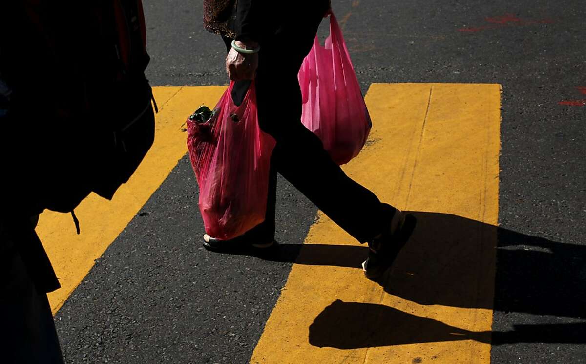 People carry plastic bags in Chinatown in San Francisco, Calif., Monday, October 1, 2012. San Francisco's city-wide plastic bag ban went into effect Monday.