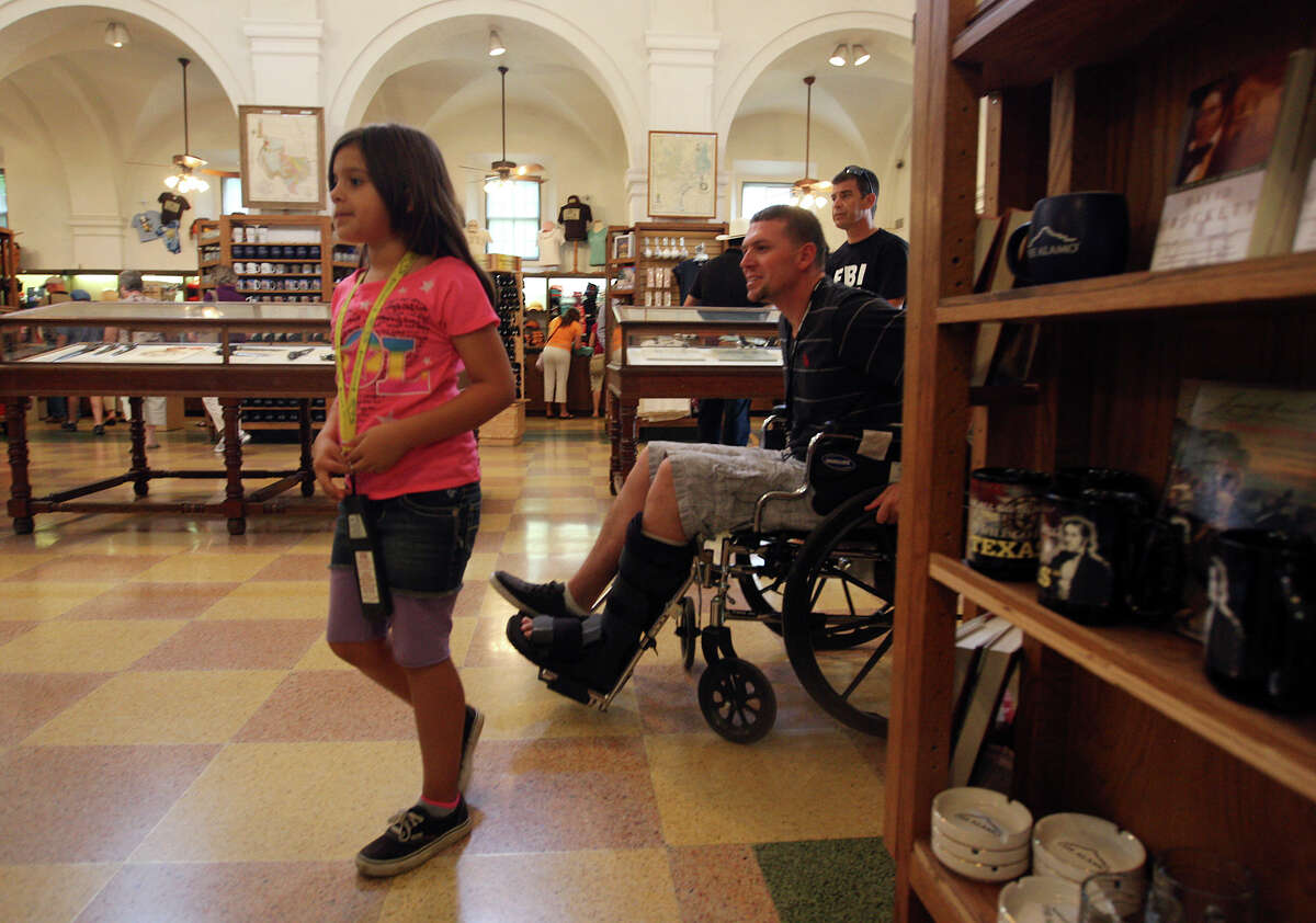 Mike Staublein, of Bakersfield, CA, and his daughter, Luciana, 8, shop at the Alamo gift shop, Monday, Oct. 1, 2012. Event Network, which manages gift shops at several historical sites nationally, has taken over the Alamo gift shop starting Monday. The General Land Office hired the firm. GLO took over the management of the Alamo from the Daughters of the Republic of Texas.