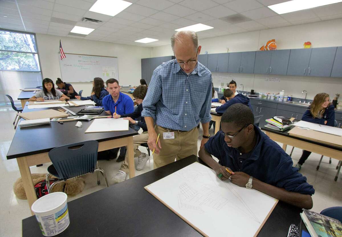 Grady Middle School Art teacher Loren Gardner teaches his classroom and Elijah Chambers, age 14, about perspective at Grady Middle School. The budget adopted early Friday includes salary increase for teachers based on years of experience. 
