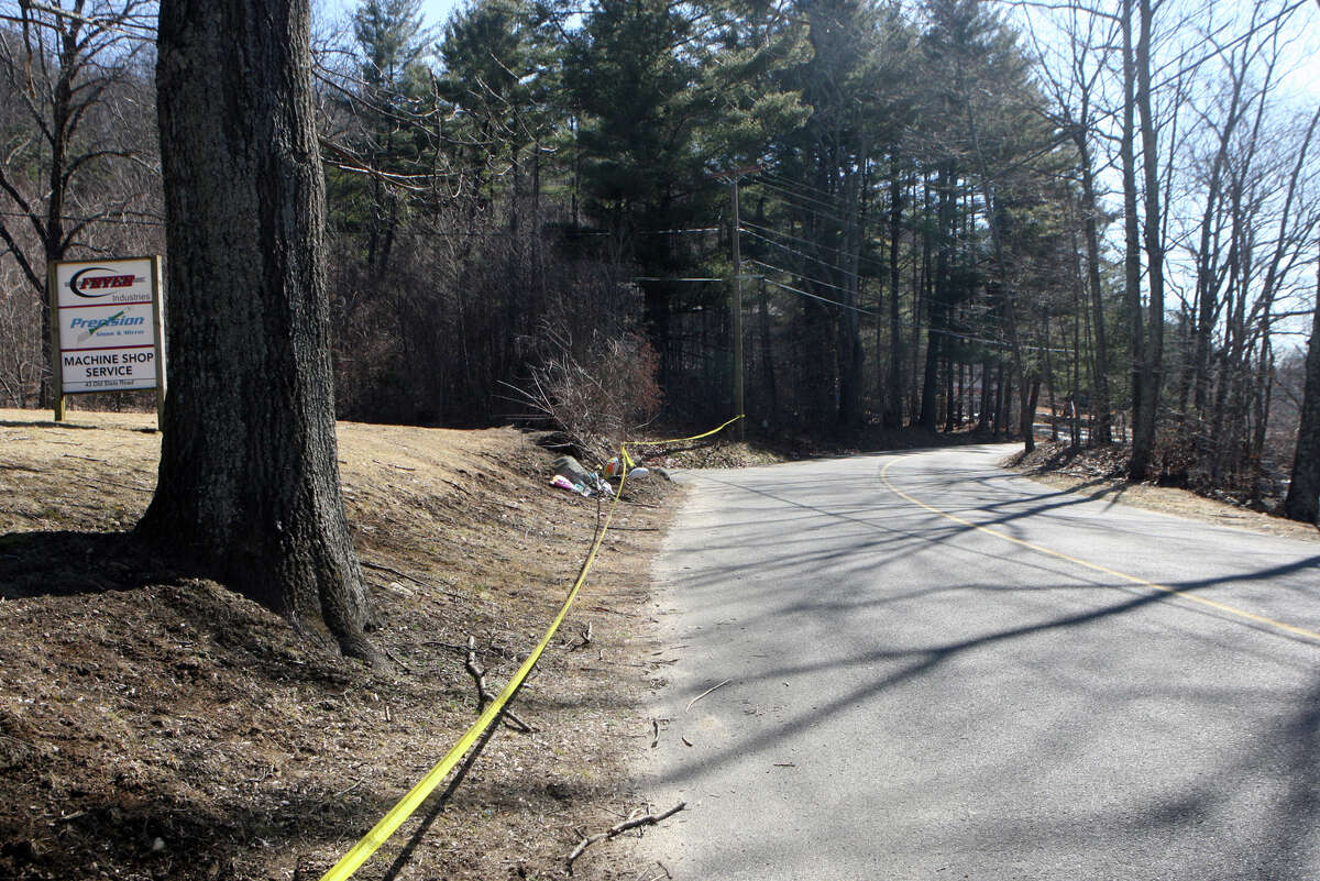 A memorial and police tape remain at the scene of a car crash on Old State Rd. in Oxford, Conn. on Sunday, March 11, 2012. Oxford High School sophomore and football player Brandon Giordano died at the scene on Friday night.