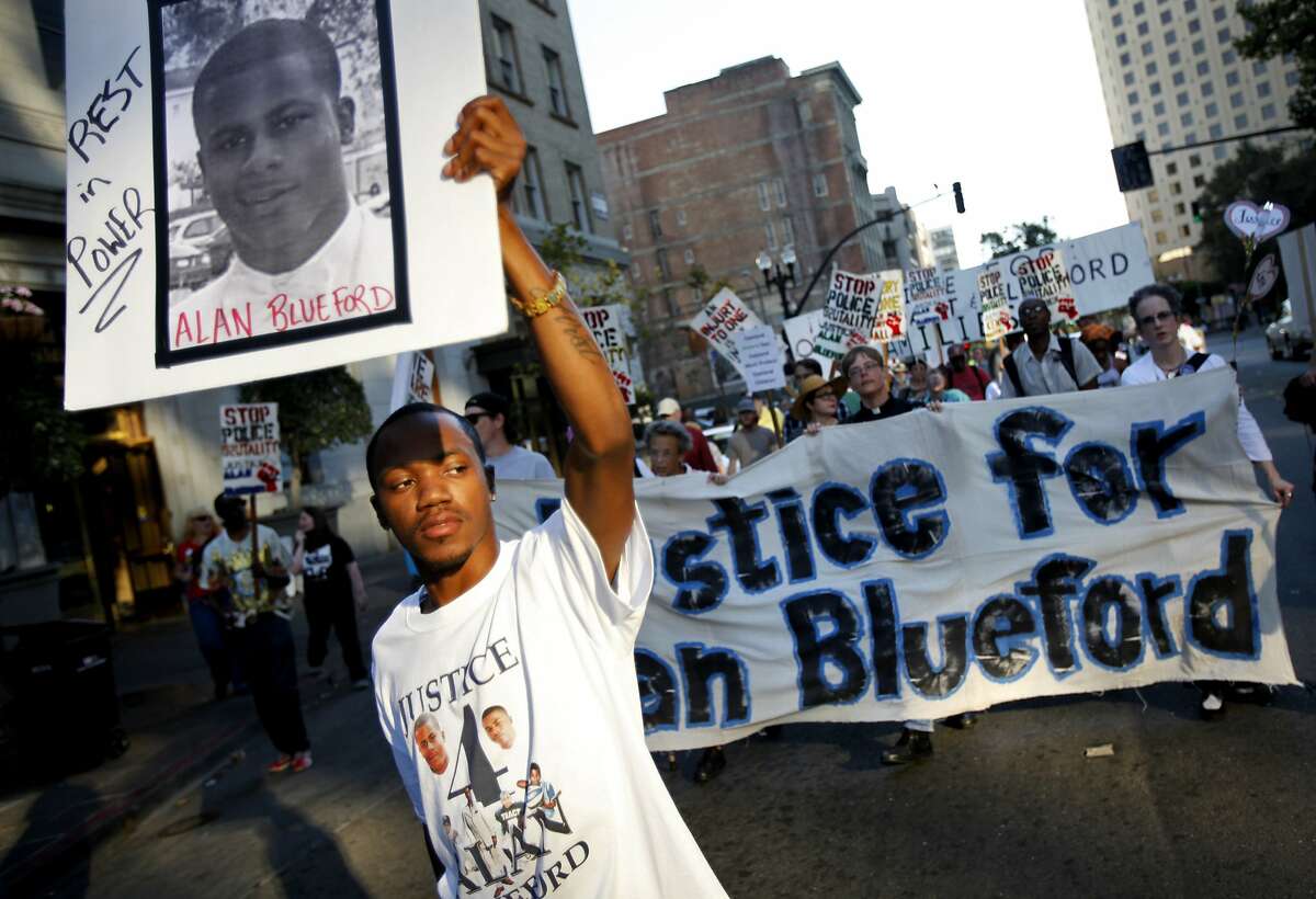 Jimmy Blueford, cousin of the slain Alan Blueford, marches through downtown Oakland to City Hall to protest at the city council meeting in Oakland, Calif., Tuesday, October 2, 2012. The family of Alan Blueford, who was killed in May by a police officer, are demanding the police finish their investigation of Blueford's shooting.