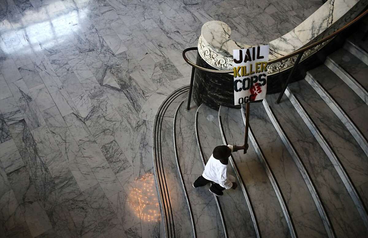 A young boy runs up the stairs at City Hall to join protestors outside the doors of the city council meeting in Oakland, Calif., Tuesday, October 2, 2012. The family of Alan Blueford, who was killed in May by a police officer, are demanding the police finish their investigation of Blueford's shooting.