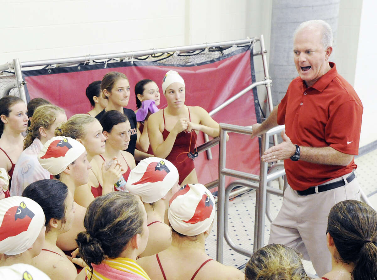 Greenwich High School girls swim coach Dick Hawks, right, speaks with his team at the start of the meet against Darien High School at Greenwich, Wednesday afternoon, Oct. 3, 2012.