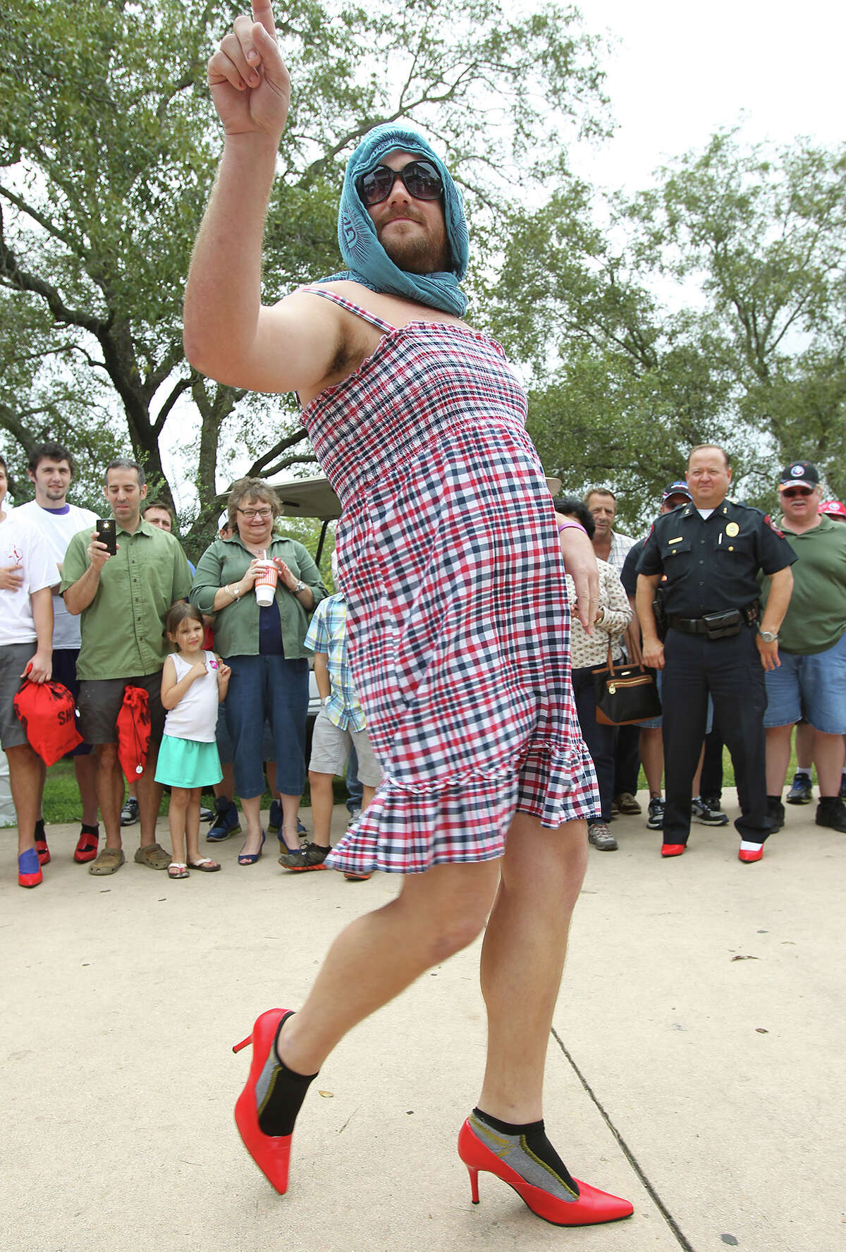 Men of Kendall County participate in "Walk a Mile in Her Shoes" to benefit the Kendall County Women's Shelter in downtown Boerne on October 3, 2012.