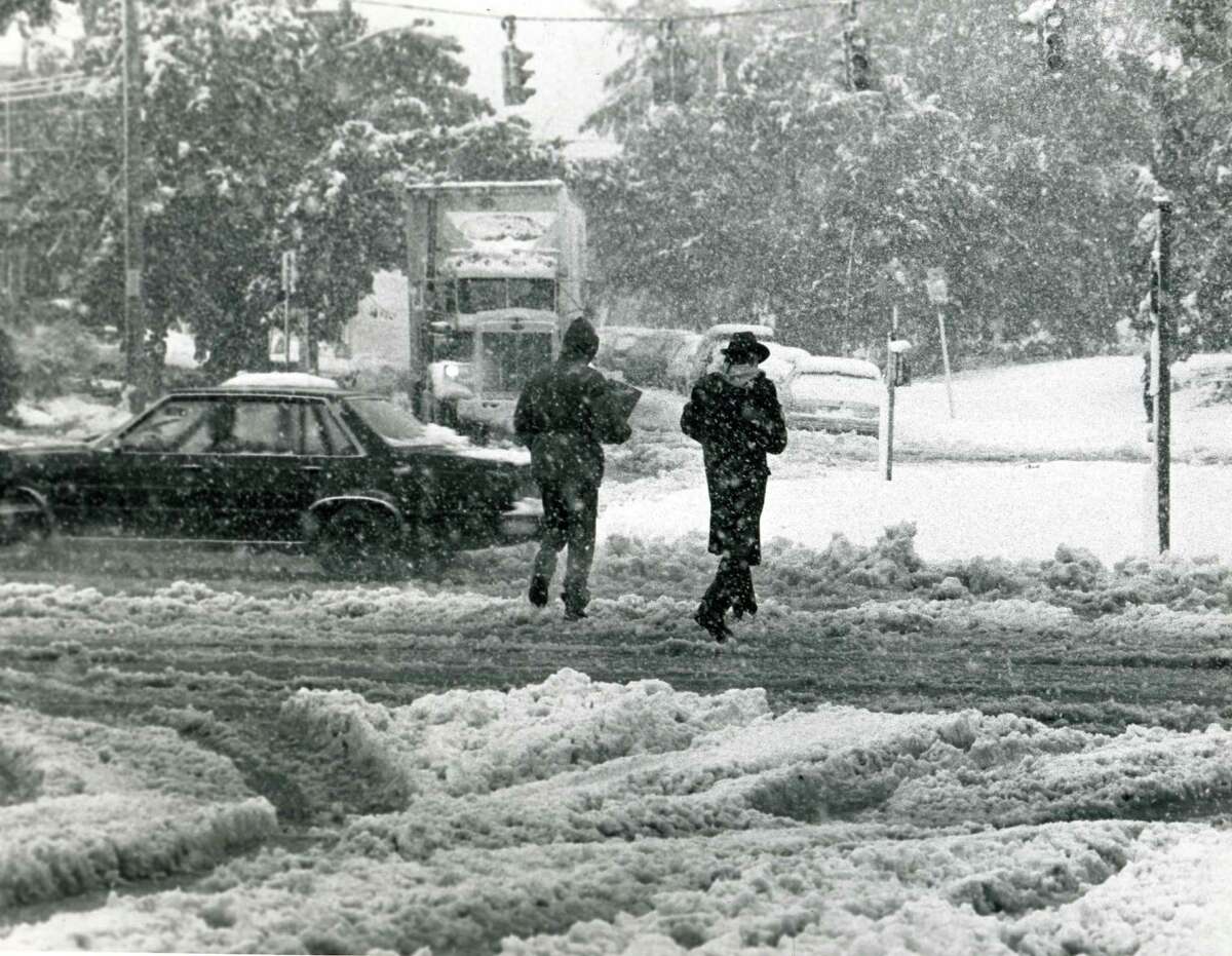 Pedestrians walk towards one of the few grocery stores open near Central Ave. and Manning Blvd. in Albany, NY, after the storm of October 4, 1987 (Jack Madigan Archives / Times Union)