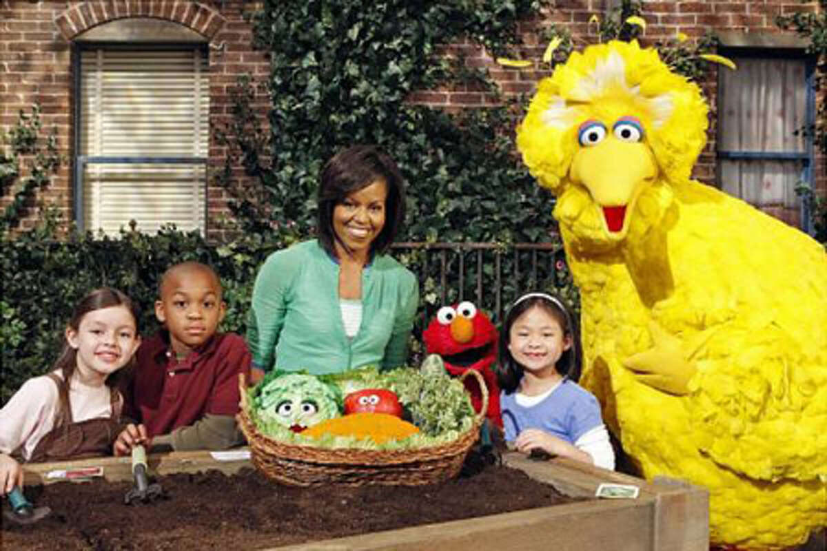Current First Lady Michelle Obama poses with Big Bird. (Richard Termine / The Associated Press)