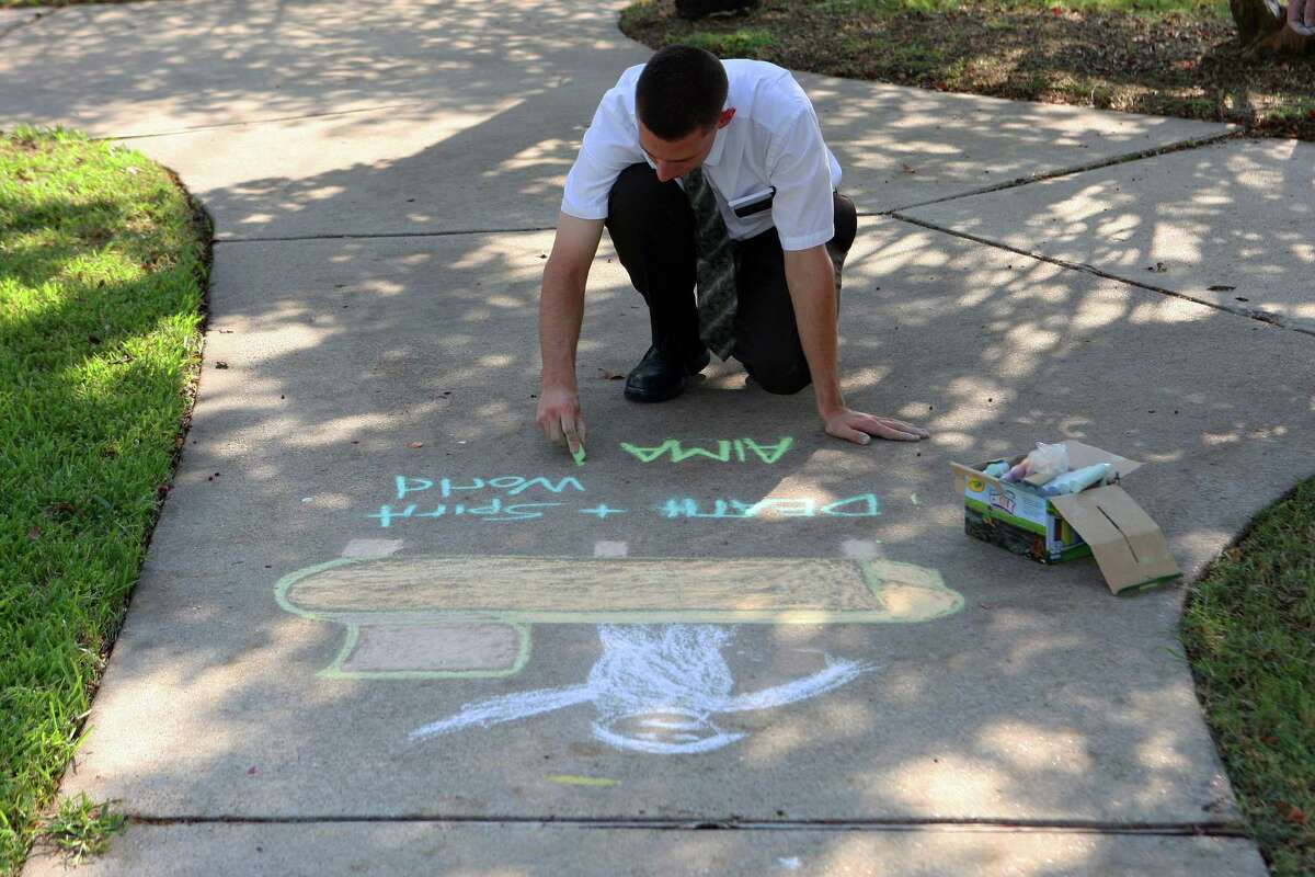 Mormon missionaries Elder Caden Jensen draws sidewalk art in the Clear Lake area as part of mission work Tuesday, Sept. 18, 2012, in Houston. The missionaries produce artwork on sidewalks in parks and neighborhoods and public areas hoping people will inquire and give them an opportunity to talk about the LDS church. ( James Nielsen / Chronicle )