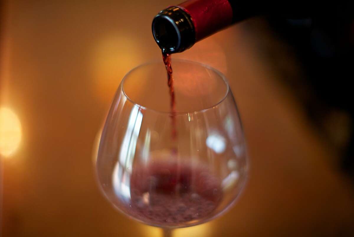 St. Innocent Winery, Salem, Oregon -- A glass of St. Innocent pinot noir is poured in the tasting room. Winemakers are in full harvest and production mode in Western Oregon as the current crop of grapes are the best in the past few growing seasons.