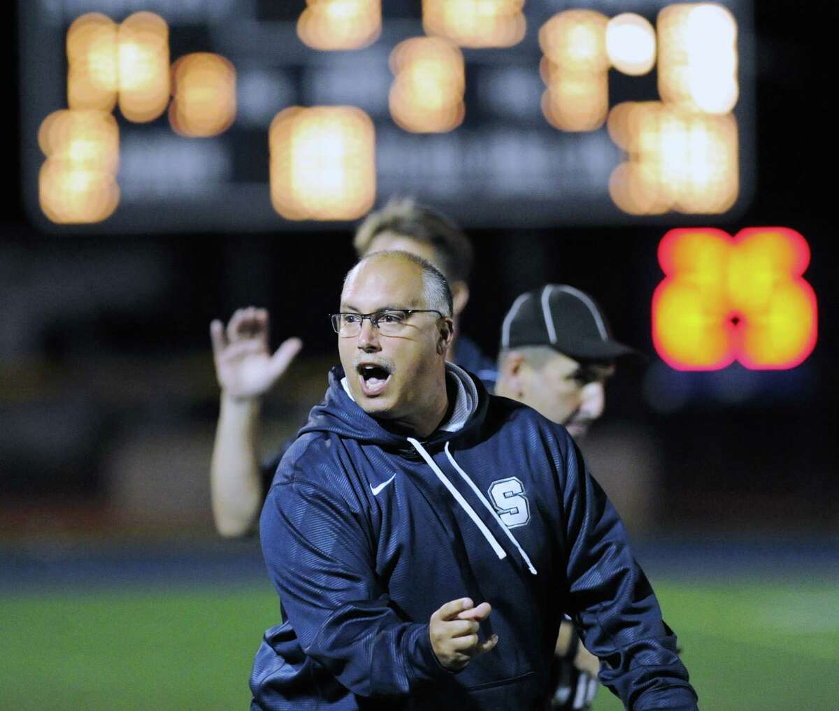 Staples High School Head Football Coach Marce Petroccio reacts after his team scored its second touchdown of the game during high school football game between Staples High School and Bridgeport Central High School at Staples in Westport, Friday night, Sept. 21, 2012.