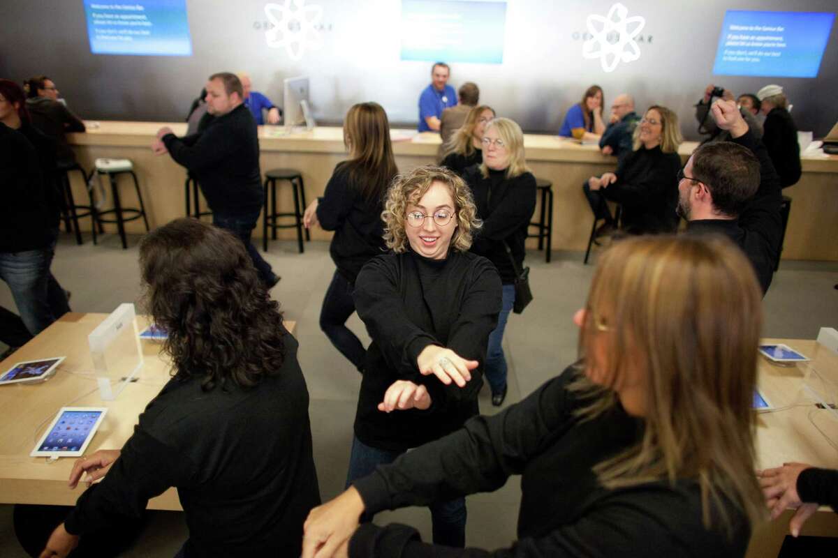 People dance to Gangnam Style during a flash mob honoring Apple co-founder Steve Jobs on Friday, Oct. 5, 2012 at the University Village Apple Store in Seattle. October 5 is the one-year anniversary of the death of the innovative technology leader. The flash mob was organized by Filter digital agency and participants wore Jobs' signature black turtlenecks, jeans and glasses. The event payed homage to Jobs' quote during a 2005 speech at Stanford University: "Stay hungry, Stay foolish!"