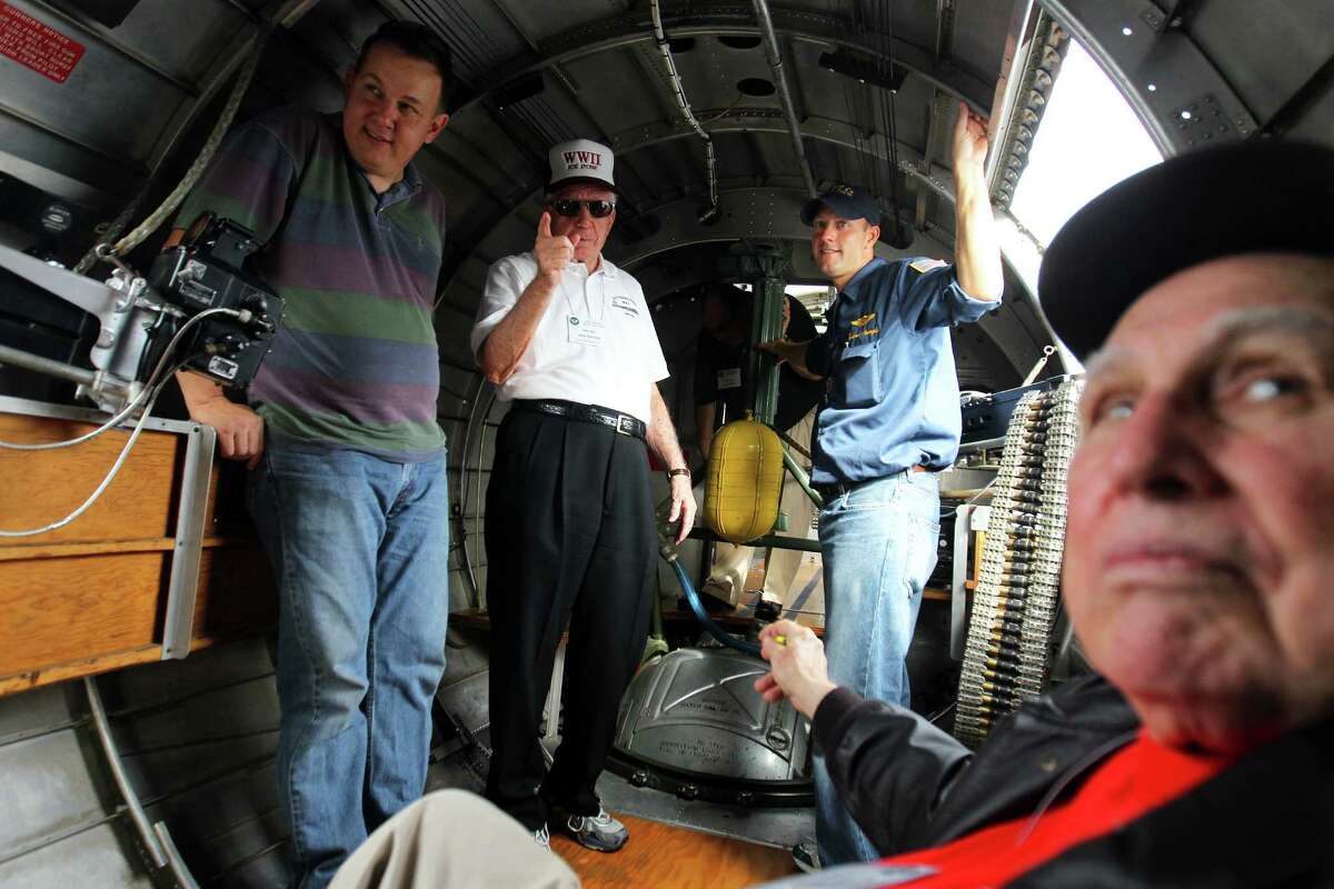 Members of the 8th Air Force Reunion group including, from left, Ivan Rasmussen, Joe Garber from Ormond Beach, FL, 89, of the 96th BG, Load Master Andrew Stample, and Joe Urice from Kerrville, 88, of the 100th BG, told stories as they waited out a weather delay before they got to ride on the WWII B-17G bomber "Sentimental Journey" as it visited Stinson Municipal Airport, Friday, October 5, 2012. There are only 5 B-17 Flying Fortresses still flying in the world, this one is maintained by the Commemorative Air Force Arizona Wing Aviation Museum in Mesa, Arizona.