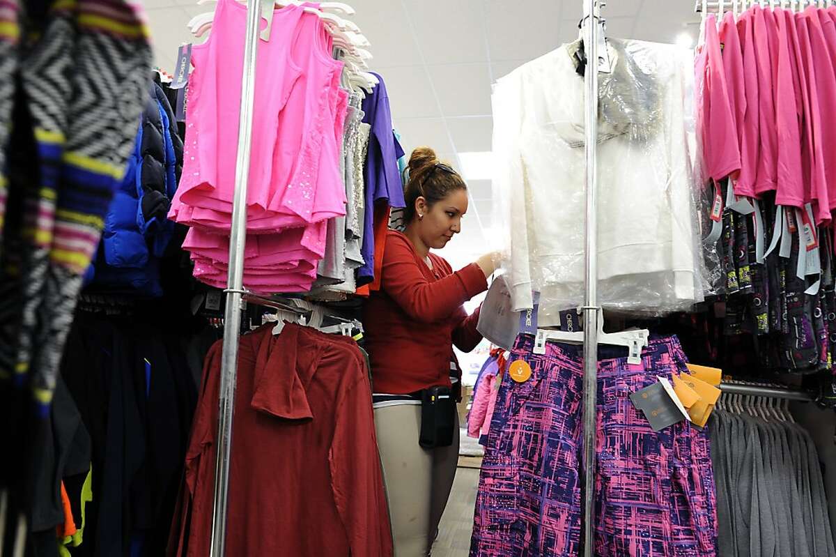 Jazmin Negrete works on a stocking a rack of young womens clothing at the new CityTarget store, which is set to open on the 14th, at the renovated Metreon in San Francisco, Calif., Tuesday October 2nd, 2012.