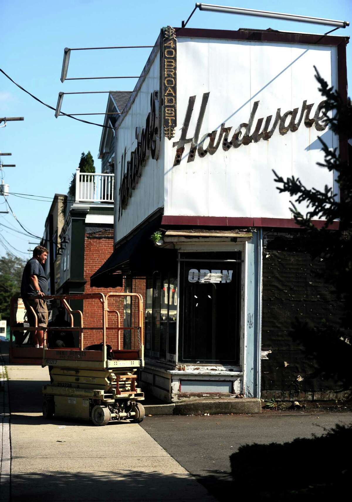 Iconic downtown Milford Harrison's Hardware sign comes down