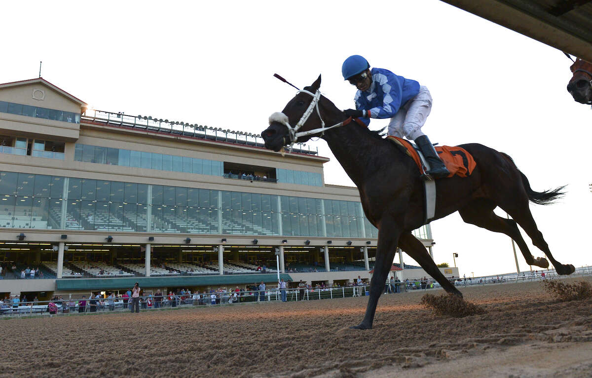 I Know Joe and jockey Jose Manuel Figueroa cross the finish line and take first place in the first race during Retama Park's opening night of the 2012 thoroughbred horse racing season in Selma, Friday, October 5, 2012. John Albright / Special to the Express-News.