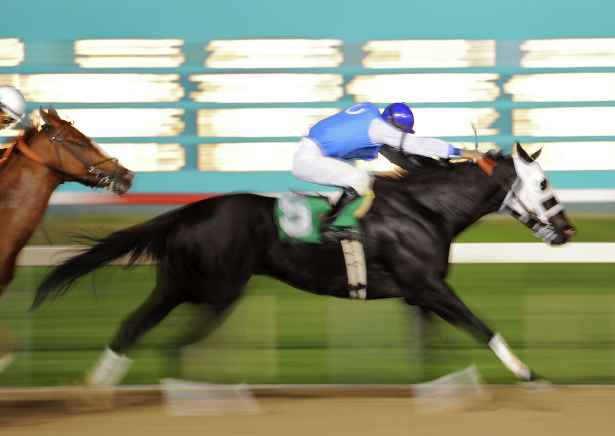 Risen in Deed (5) is just a blur as it races past to win the fourth race during Retama Park's opening night of the 2012 thoroughbred horse racing season in Selma, Friday, October 5, 2012. John Albright / Special to the Express-News.