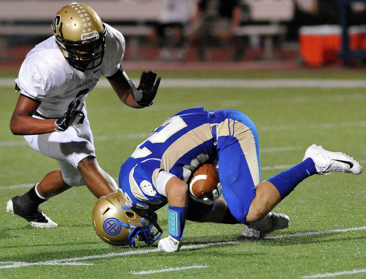 Seguin's Colton Applewhite, left, closes in on Alamo Heights' Christian Biedenharn during a high school football game, Friday, Oct. 5, 2012, at Alamo Heights High School in San Antonio.