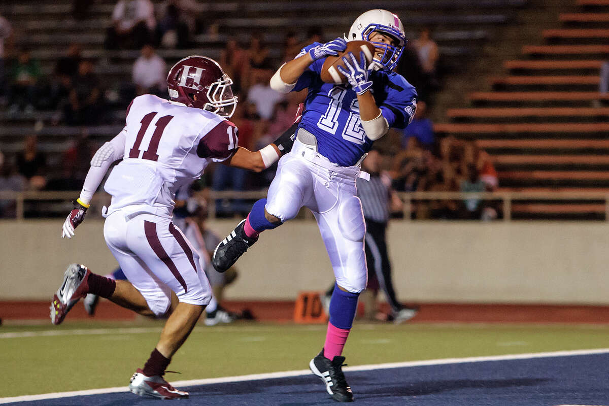 Lanier's Hectyor Dehoyos (right) comes down with a twenty-one yard touchdown reception over Highlands' Thomas Martinez during the third quarter of their game at Alamo Stadium on Oct. 5, 2012. MARVIN PFEIFFER/ mpfeiffer@express-news.net