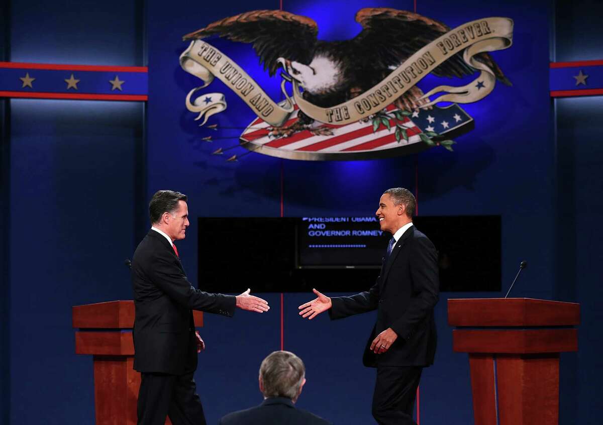 DENVER, CO - OCTOBER 03: Democratic presidential candidate, U.S. President Barack Obama (R) reaches out to shake hands with Republican presidential candidate, former Massachusetts Gov. Mitt Romney (L) during the Presidential Debate at the University of Denver on October 3, 2012 in Denver, Colorado. The first of four debates for the 2012 Election, three Presidential and one Vice Presidential, is moderated by PBS's Jim Lehrer and focuses on domestic issues: the economy, health care, and the role of government. (Photo by Win McNamee/Getty Images)