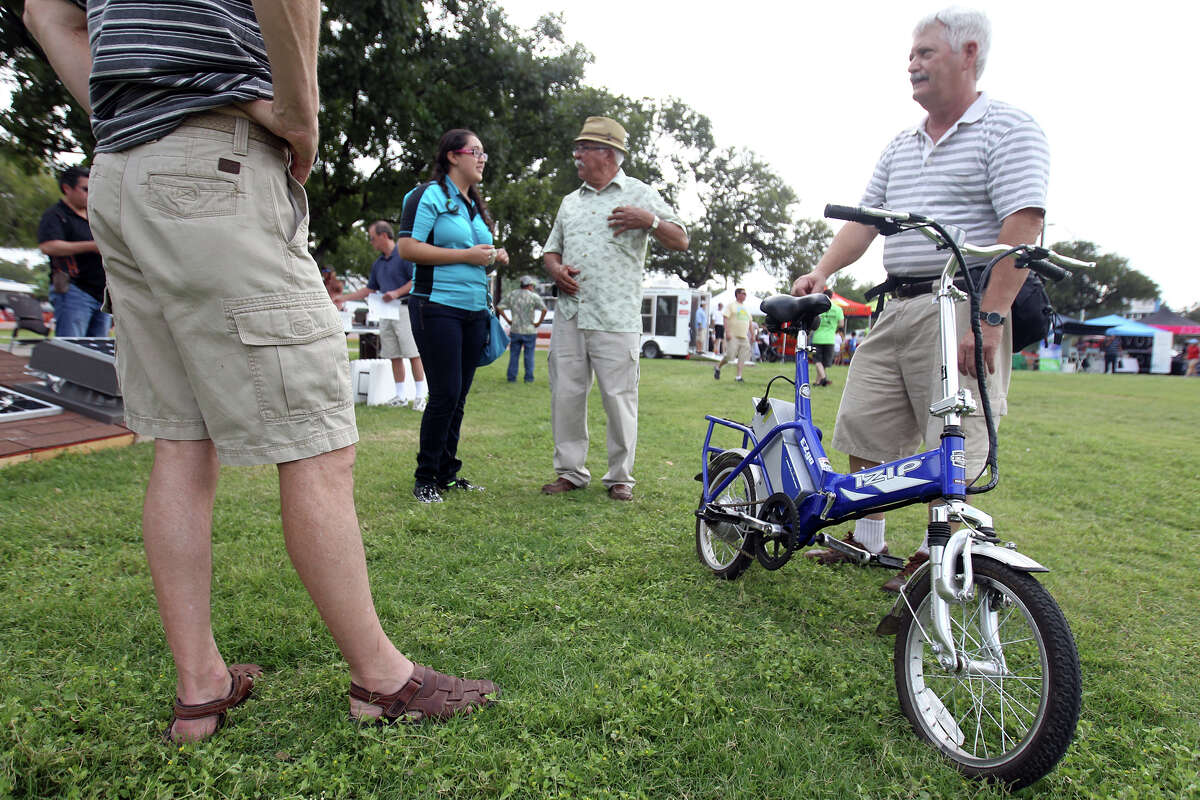 Charles Schneider of Pleasanton shows off his folding electric bicycle during Solar Fest San Antonio at Lion's Field on Saturday, Oct. 6, 2012.