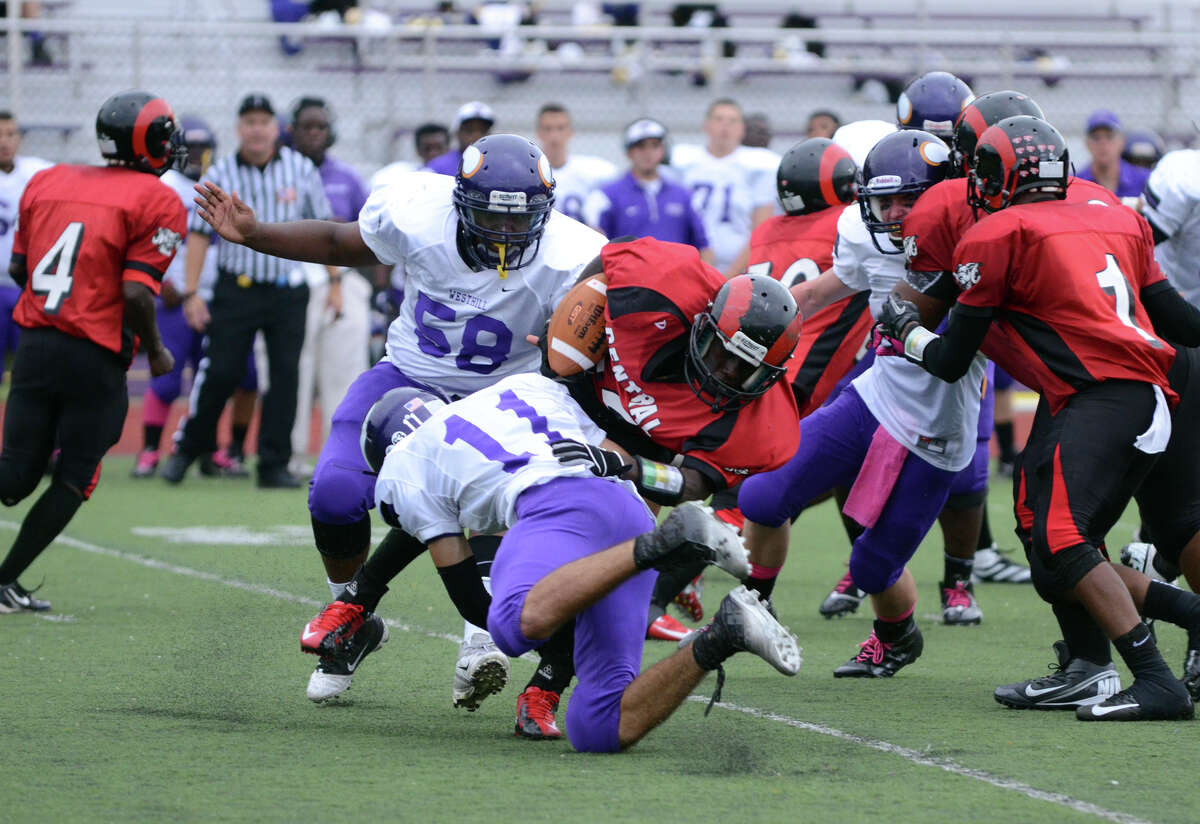 Westhill'sNick Jimenez (11) takes down Central's Anderson Cherilus (22) during the football game at Westhill High School on Saturday, Oct. 6, 2012.
