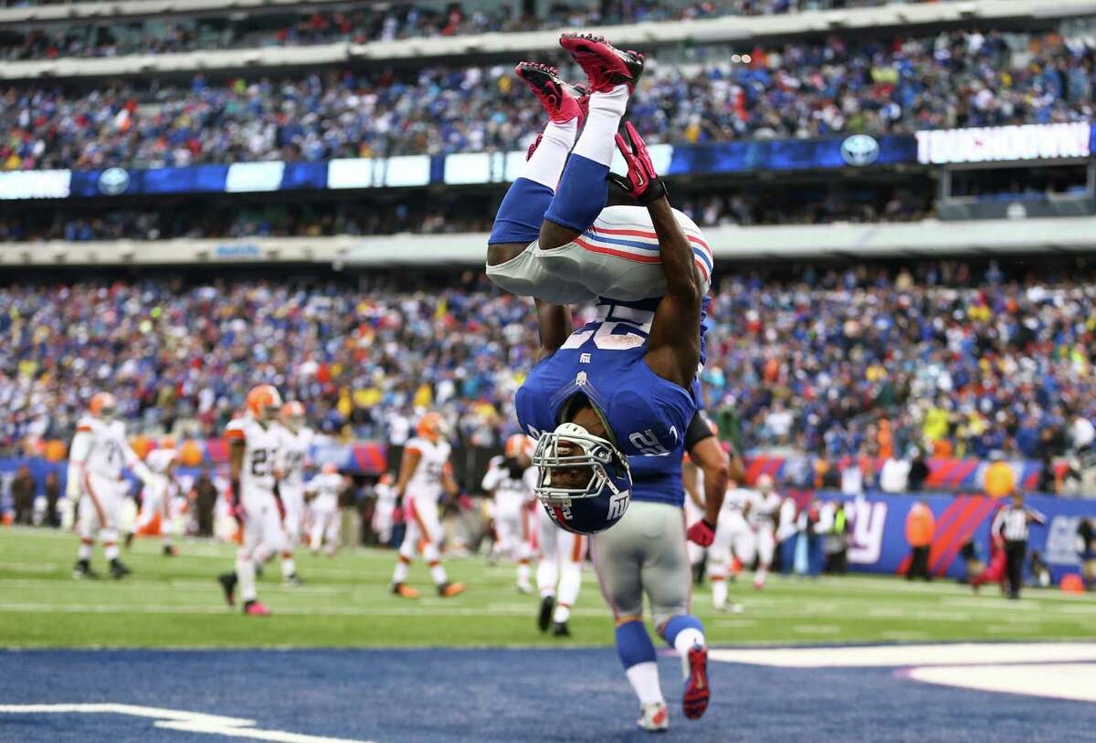 EAST RUTHERFORD, NJ - OCTOBER 07: David Wilson #22 of the New York Giants celebrates his touchdown against the Cleveland Browns by doing a backflip during their game at MetLife Stadium on October 7, 2012 in East Rutherford, New Jersey. (Photo by Al Bello/Getty Images) *** BESTPIX ***
