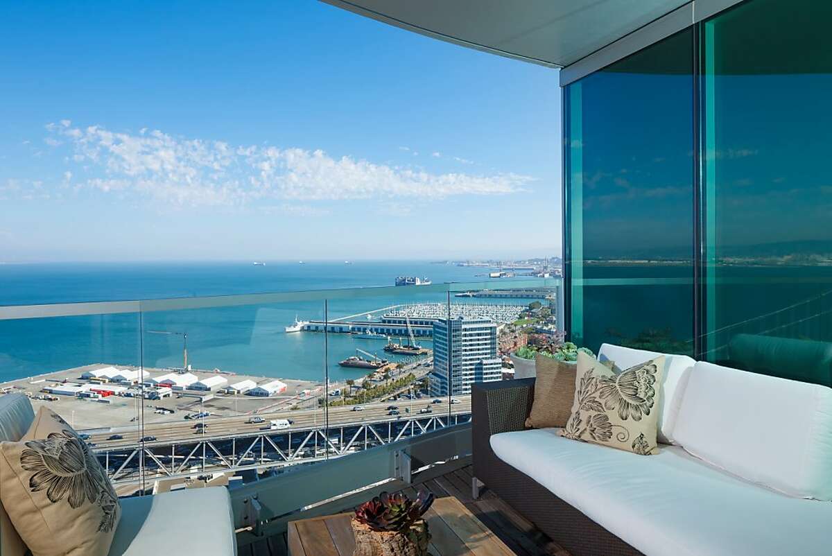 Panoramic views from the upper-level guest deck, the home's second terrace buffered by a half-wall of glass, extend outward with the Pacific Ocean.