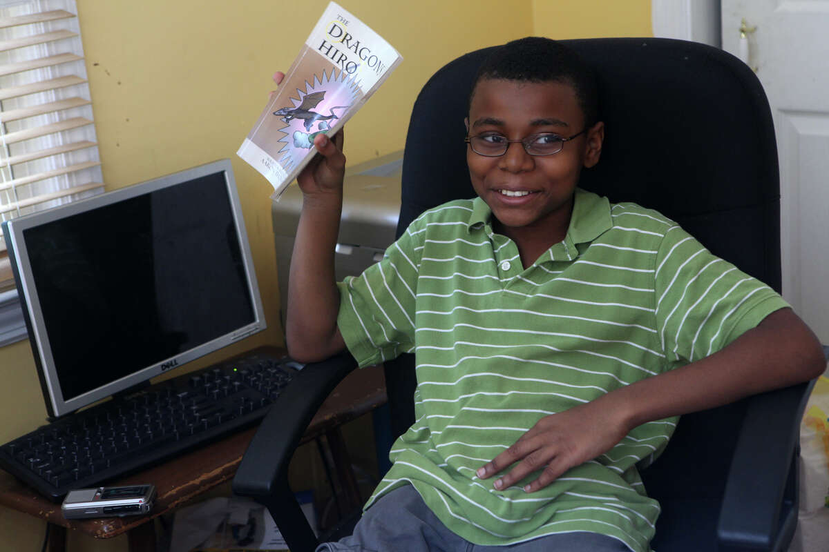 Aaron Thomas Russell, 12, of Bridgeport, Conn, talks about his published book in his home office on Monday, October 8, 2012.