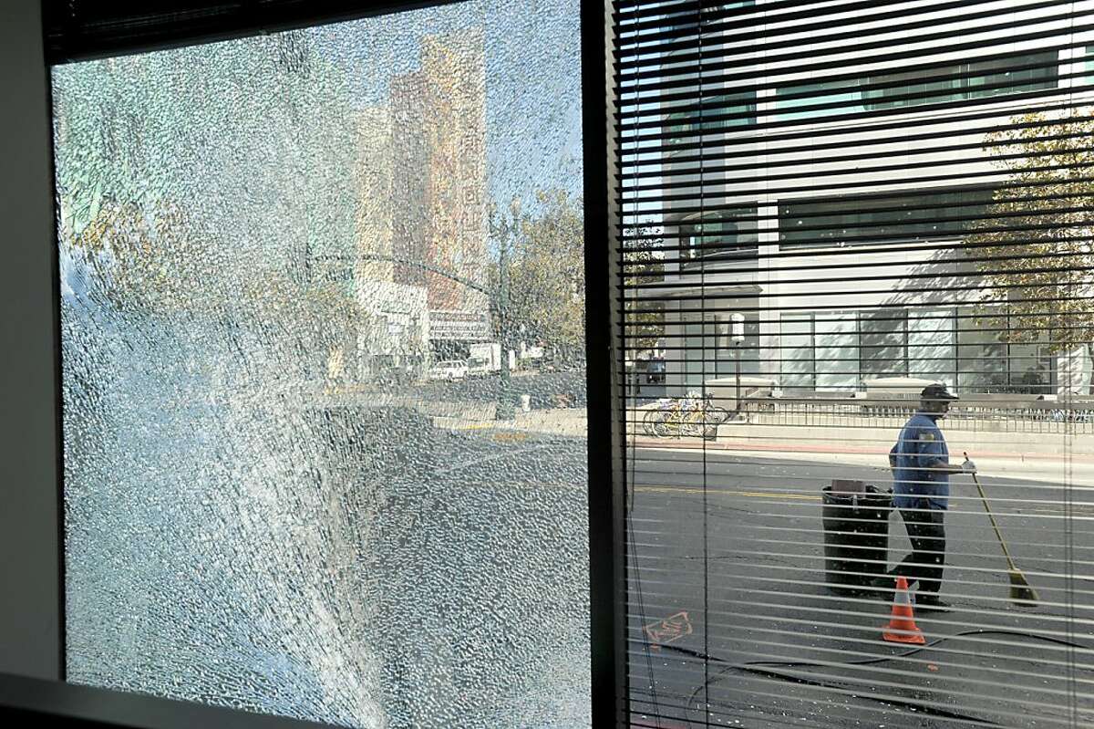 Following a violent anti-war protest Sunday night, a broken window awaits repair at the Oakland Tribune's offices on Monday, Oct. 8, 2012, in Oakland, Calif.