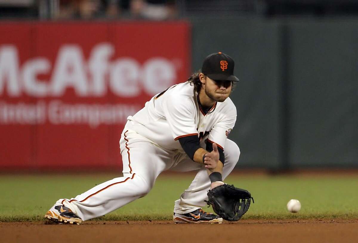 Brandon Crawford fields a ball hit by Paul Goldschmidt during the game against the Diamondbacks on Wednesday. The San Francisco Giants played the Arizona Diamondbacks at AT&T Park in San Francisco, Calif., on Wednesday, September 26, 2012, defeating the Diamondbacks 6-0
