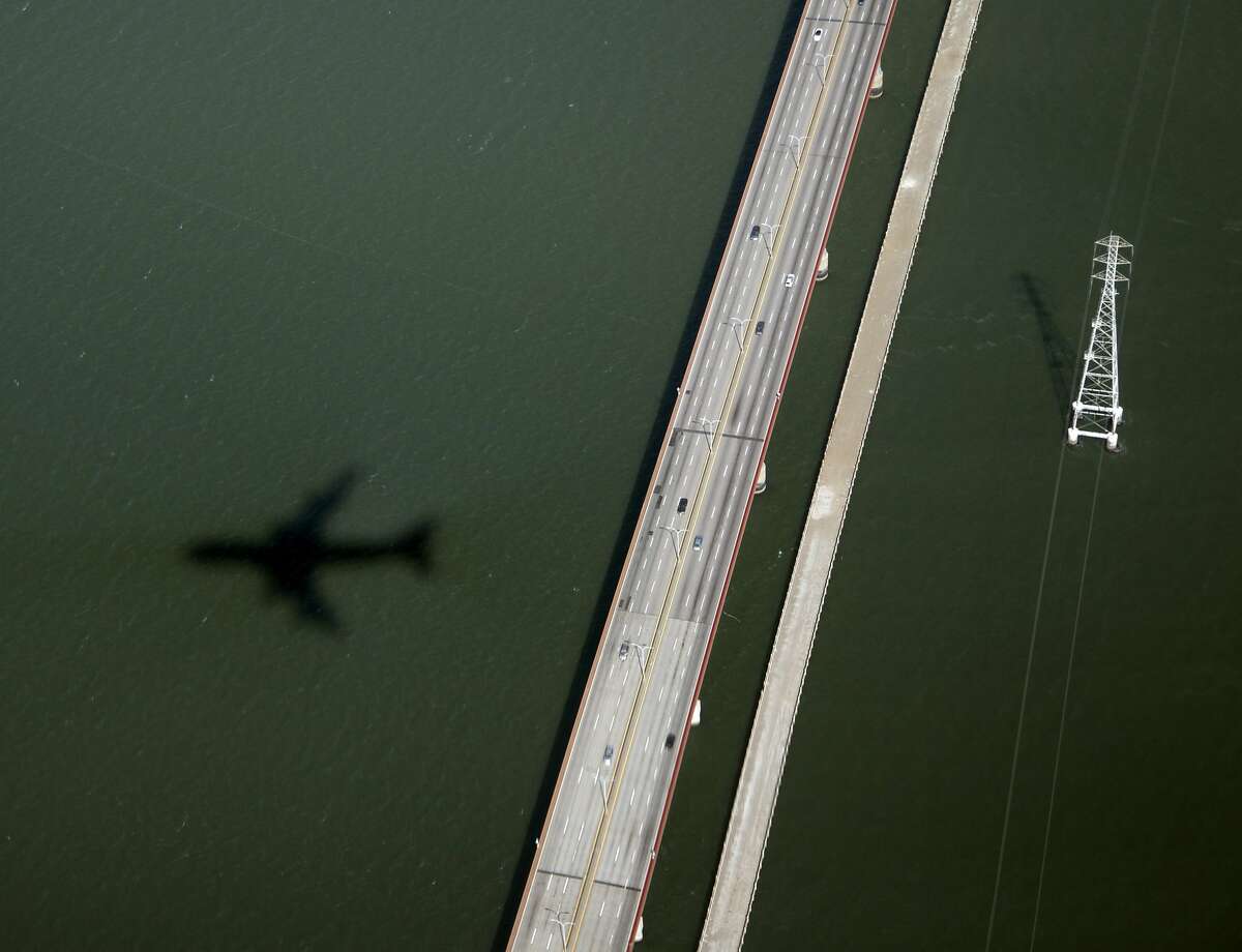 The shadow of Air Force One with President Barack Obama aboard is seen as it flies over the San Mateo Bridge and San Francisco Bay en rout to the San Francisco International Airport , Monday, Oct. 8, 2012, in San Francisco. (AP Photo/Carolyn Kaster)