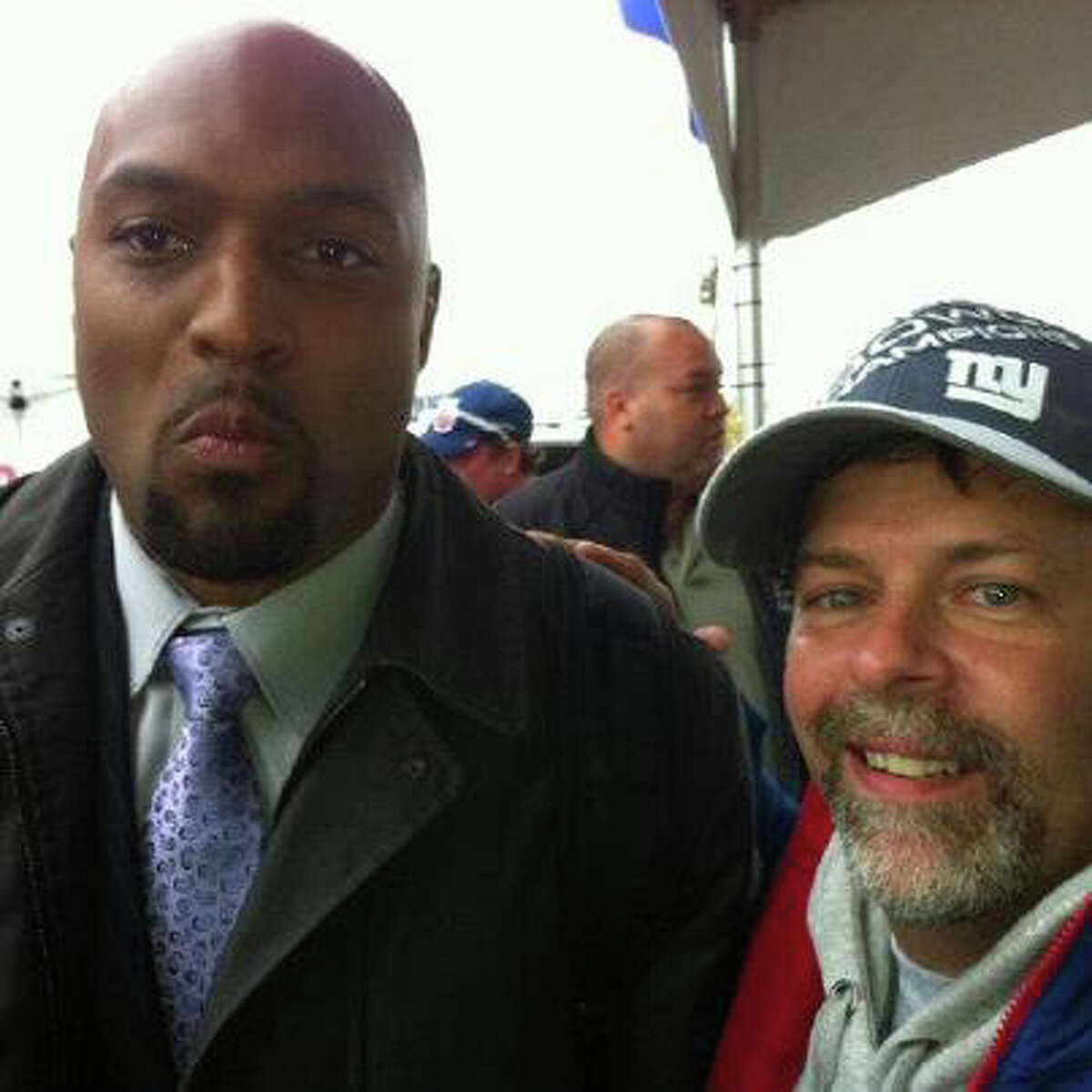 Former New York Giant Amani Toomer and Long Island Giants fan Anthony Scorcia after the Giants win over the Cleveland Browns on Oct. 7, 2012. Scorcia gave away an extra ticket to a fan who lost his -- and got invited to a post-game tailgate where he got to meet some of his heroes. (Anthony Scorcia)