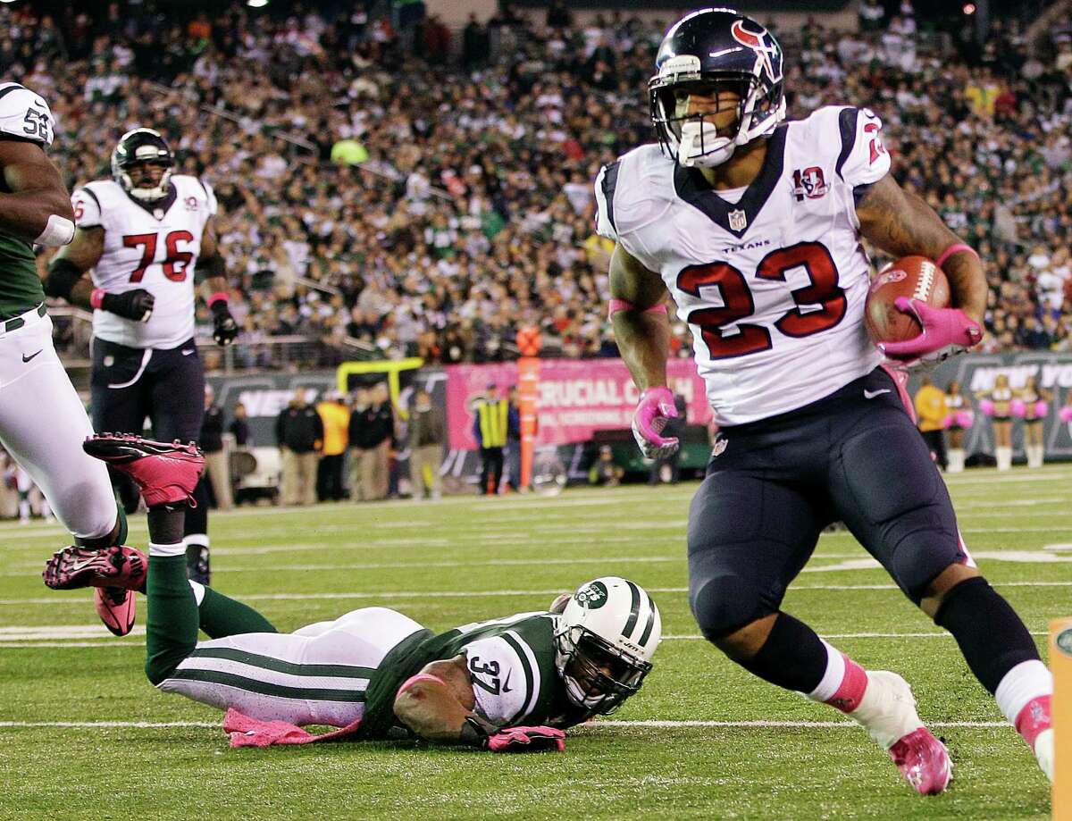 Houston Texans running back Arian Foster (23) rushes for a touchdown as New York Jets strong safety Yeremiah Bell (37) falls down on the play during the first half of an NFL football game, Monday, Oct. 8, 2012, in East Rutherford, N.J. (AP Photo/Kathy Willens)