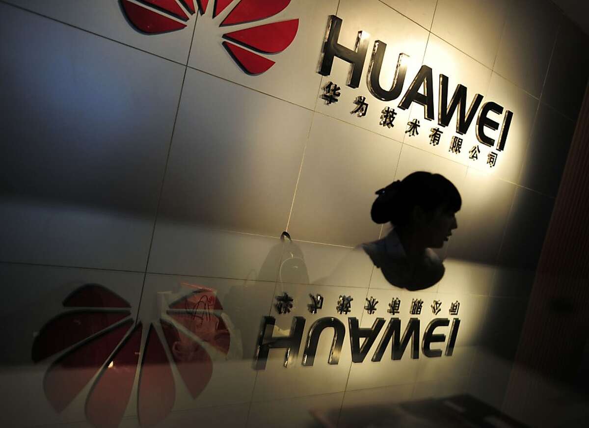In this Monday, Oct. 8, 2012 photo, an employee works at a reception counter of a R&D center of Huawei Technologies Inc. in Wuhan, in central China's Hubei province. Eager to expand in the United States, China's biggest technology companies face American anxiety about security and rising Chinese competition.(AP Photo) CHINA OUT