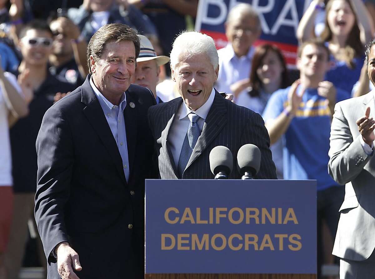 Former President Bill Clinton, right, joins with Rep. John Garamendi, D-Calif during a campaign rally at the University of California, Davis, in Davis, Calif., Tuesday, Oct. 9, 2012. Clinton was campaigning for Garamendi and other California Congressional candidates.(AP Photo/Rich Pedroncelli)