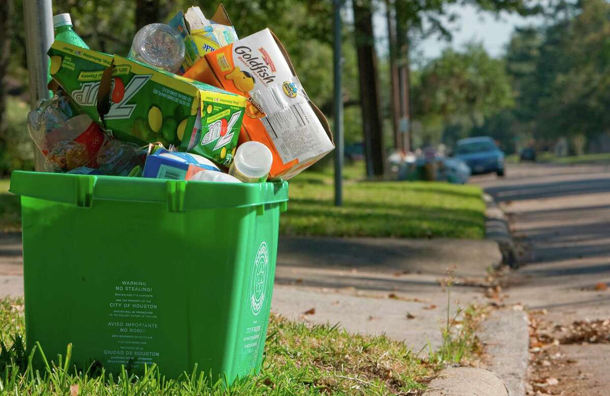A full recycle container sits on the curb in the 4900 block of Oak Forest in northwest Houston. The city of Houston's curbside recycle program is still on hold while the city continues to focus on removal of vast amounts of storm debris. Areas such as the Oak Forest subdivision does not yet have their recycling restored. (Thursday, Oct. 9, 2008, in Houston. ( Steve Campbell / Houston Chronicle)