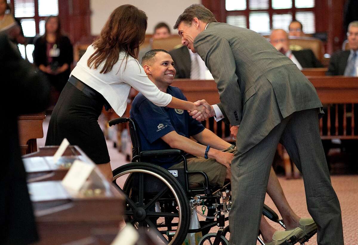 The injured Esquivel was presented a Star of Texas Award by Gov. Rick Perry in September 2012. Perry has already vetoed a texting-while-driving ban and has hinted he’ll do it again. (AP Photo/Statesman.com, Ralph Barrera)