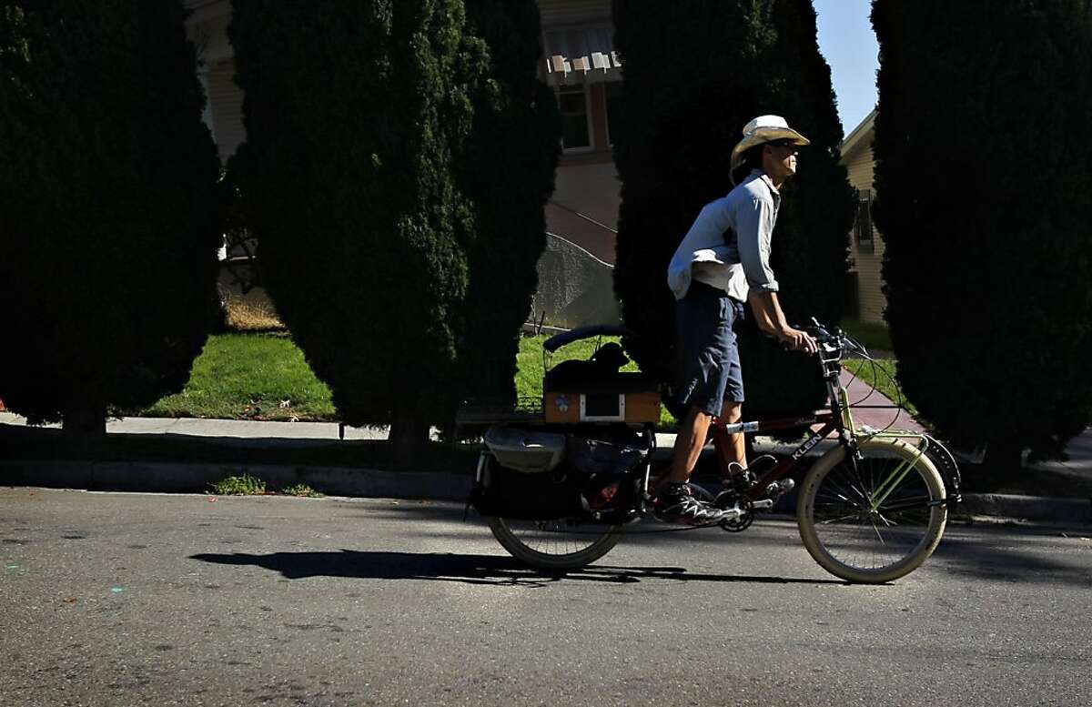 Jim Hsu turned his bike into a "Trudimobile" to haul around his six-year-old dachshund Trudi. He shows off his bike at home in Oakland, Calif., Monday, October 8, 2012.