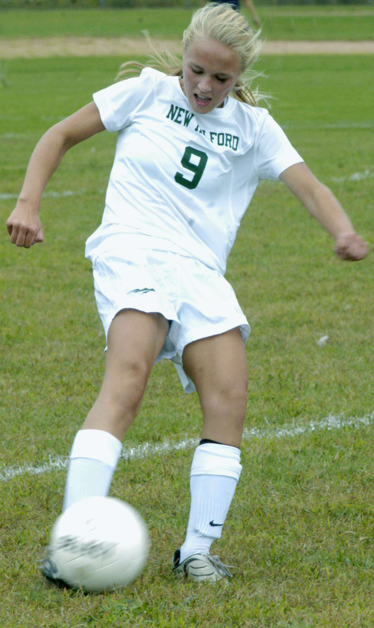 THe Green Wave's Claudia Taylor strikes a crossing pass from the right wing during New Milford High School girls' soccer's Sept. 22, 2012 match vs. Kolbe Cathedral at NMHS.