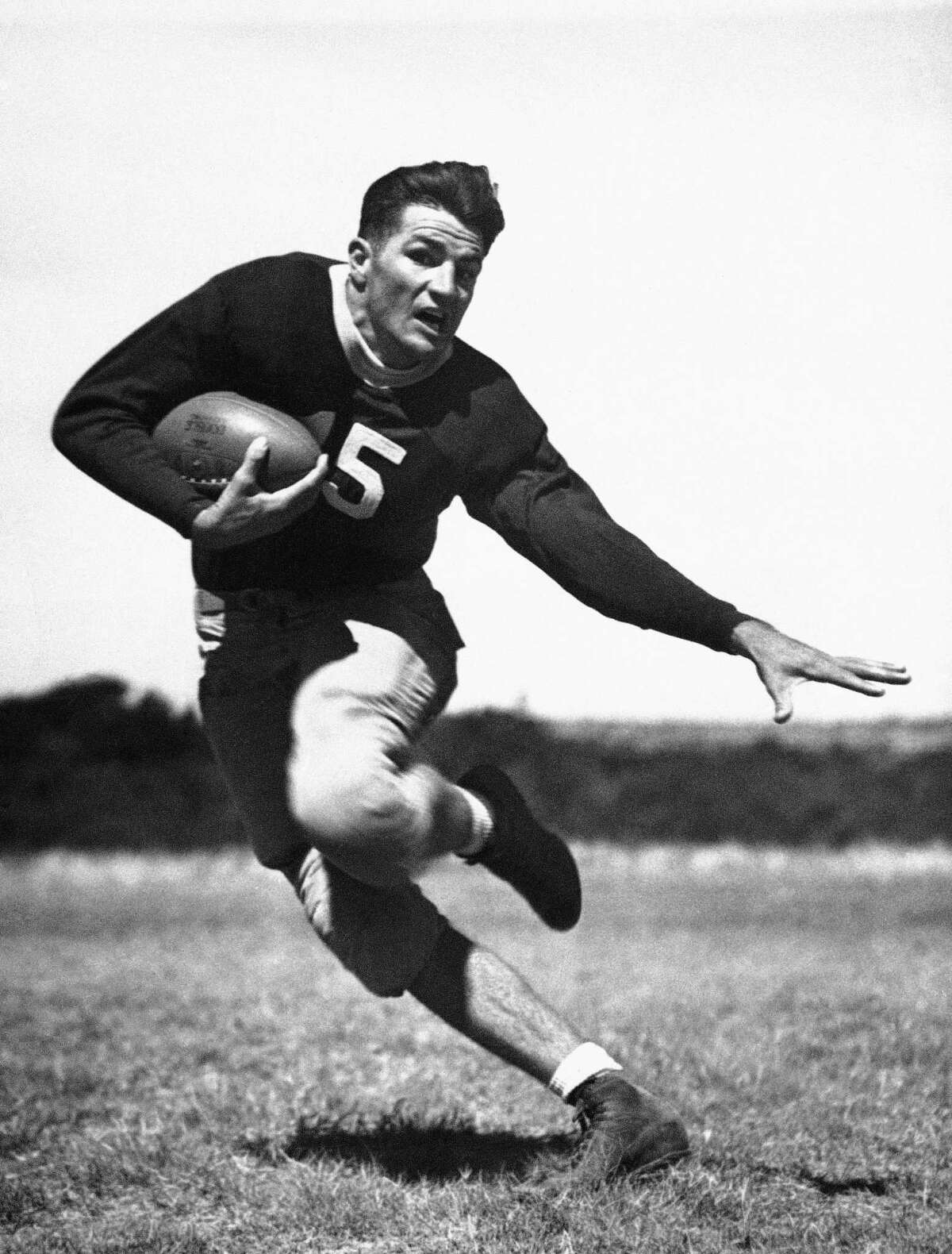 In this Dec. 15, 1936 file photo, Sammy Baugh, backfield star of Texas Christian University, is demonstrating his sidestepping ability in Dallas. 