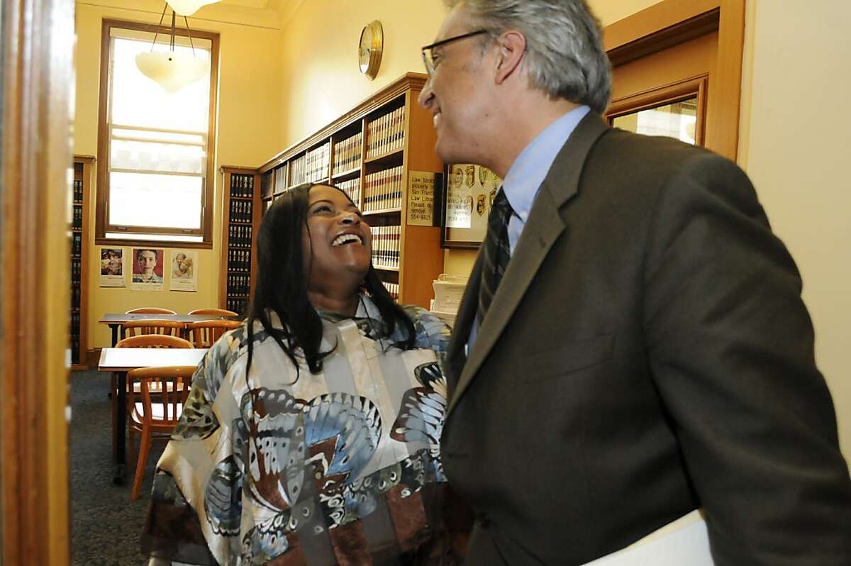 Reinstated Sheriff Ross Mirkarimi greets Karla Guillory, senior legal clerk, in his office Wednesday, Oct. 10, 2012.
