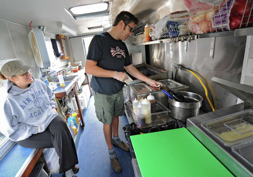 Andrea Loguidice and her boyfriend Brandon Snooks, both of Schenectady, work on the Wandering Dago food truck outside Schenectady County Public Library Tuesday, Oct. 9, 2012 in Schenectady, N.Y. (Lori Van Buren / Times Union)