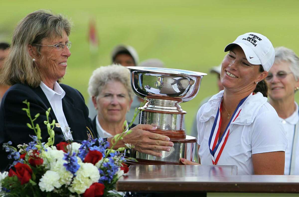 USGA's Barbara Barrow (left) hands the winner's trophy to Meghan Stasi of Oakland Park, Florida after Stasi defeated Liz Waynick of Scottsdale, Arizona, 6&5, at the USGA U.S. Women's Mid-Amateur Championships at Briggs Ranch Golf Club on Thursday, Oct. 11, 2012. Stasi won the title for the fourth time.