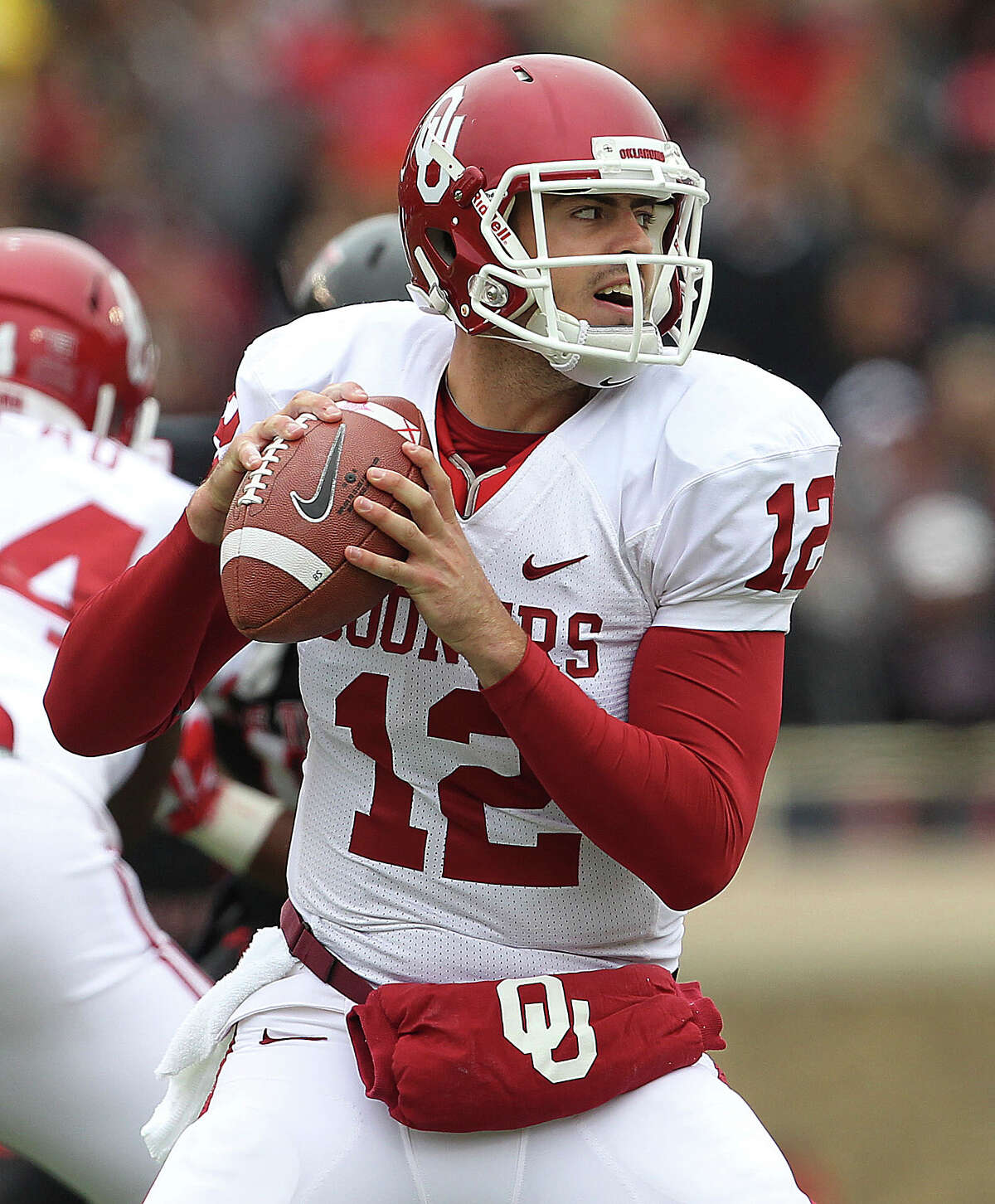 Oklahoma's Landry Jones looks to throw against Texas Tech during an NCAA college football game in Lubbock, Saturday, Oct. 6, 2012.