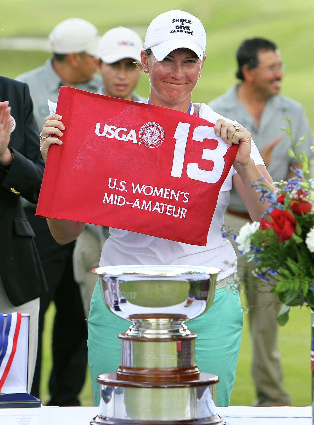 Meghan Stasi of Oakland Park, Florida shows the flag at the hole which she eventually defeated Liz Waynick of Scottsdale, Arizona, 6&5, during the trophy presentation at the USGA U.S. Women's Mid-Amateur Championships at Briggs Ranch Golf Club on Thursday, Oct. 11, 2012. Stasi won the title for the fourth time.