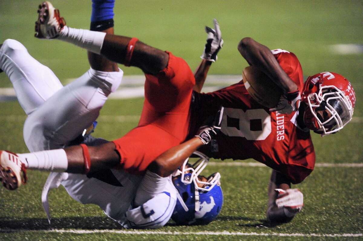 Receiver P.J. Anderson of Taft (8) is tackled by Dae Ross (7) of Jay during District 27-5A football action at Farris Stadium on Thursday, Oct. 11, 2012.