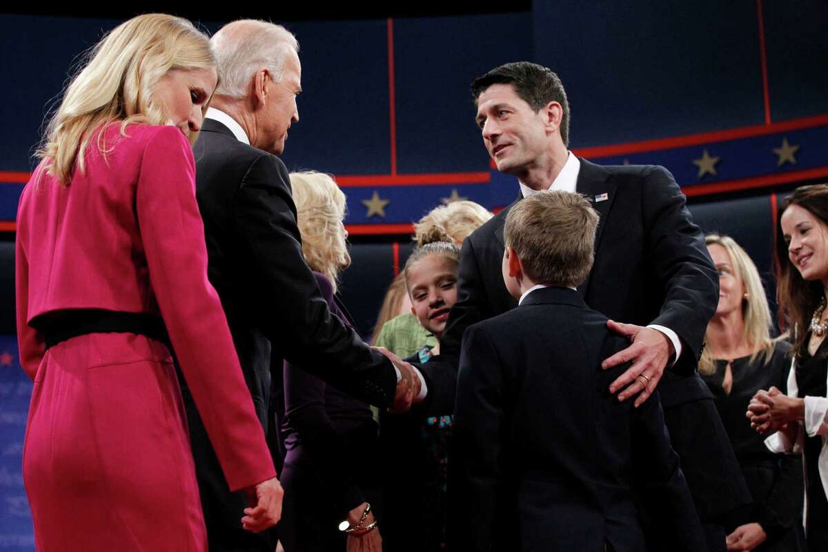 Vice President Joe Biden greets U.S. Rep. Paul Ryan at the end of their debate Thursday night. Ryan is joined by his wife, Janna, left, daughter Liza and son Charlie.
