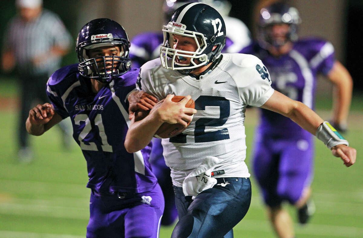 Rangers quarterback Garrett Smith rolls for a first down past the Rattlers' Nick Manrique as San Marcos plays Smithson Valley at Bobcat Stadium in San Marcos on Oct. 11, 2012.