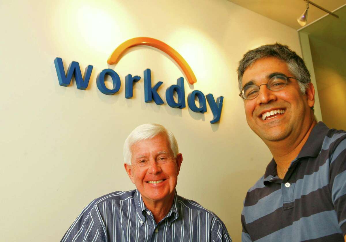 In this photo from 2007, Dave Duffield, left and Aneel Bhusri (co-founder and president) pose in front of the company logo in the reception room of the Walnut Creek office. After fighting the hostile takeover of his company, PeopleSoft, Dave Duffield founded a new startup in Walnut Creek with 107 employees called Workday. And that startup is taking bold aim at his old nemesis, Oracle's Larry Ellison, by selling software that lets companies manage business tasks via the Internet instead of installing costly programs on company computers. Photo by Michael Maloney / San Francisco Chronicle Photo taken on 6/8/07 in Walnut Creek, CA *** Ran on: 06-17-2007 David Duffield relaxes in a beanbag chair in the game room at Workday, where the congenial atmosphere is a reminder of his days at PeopleSoft. Ran on: 06-17-2007 David Duffield relaxes in a beanbag chair in the game room at Workday, where the congenial atmosphere is a reminder of his days at PeopleSoft.